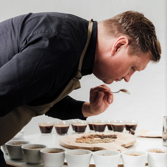 BKIs expert cupper smell the coffee as part of the taste test 