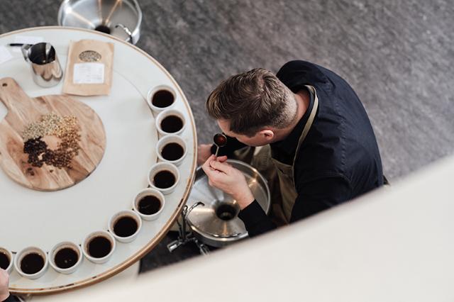 BKI expert cupper seen taste testing the coffee to ensure quality